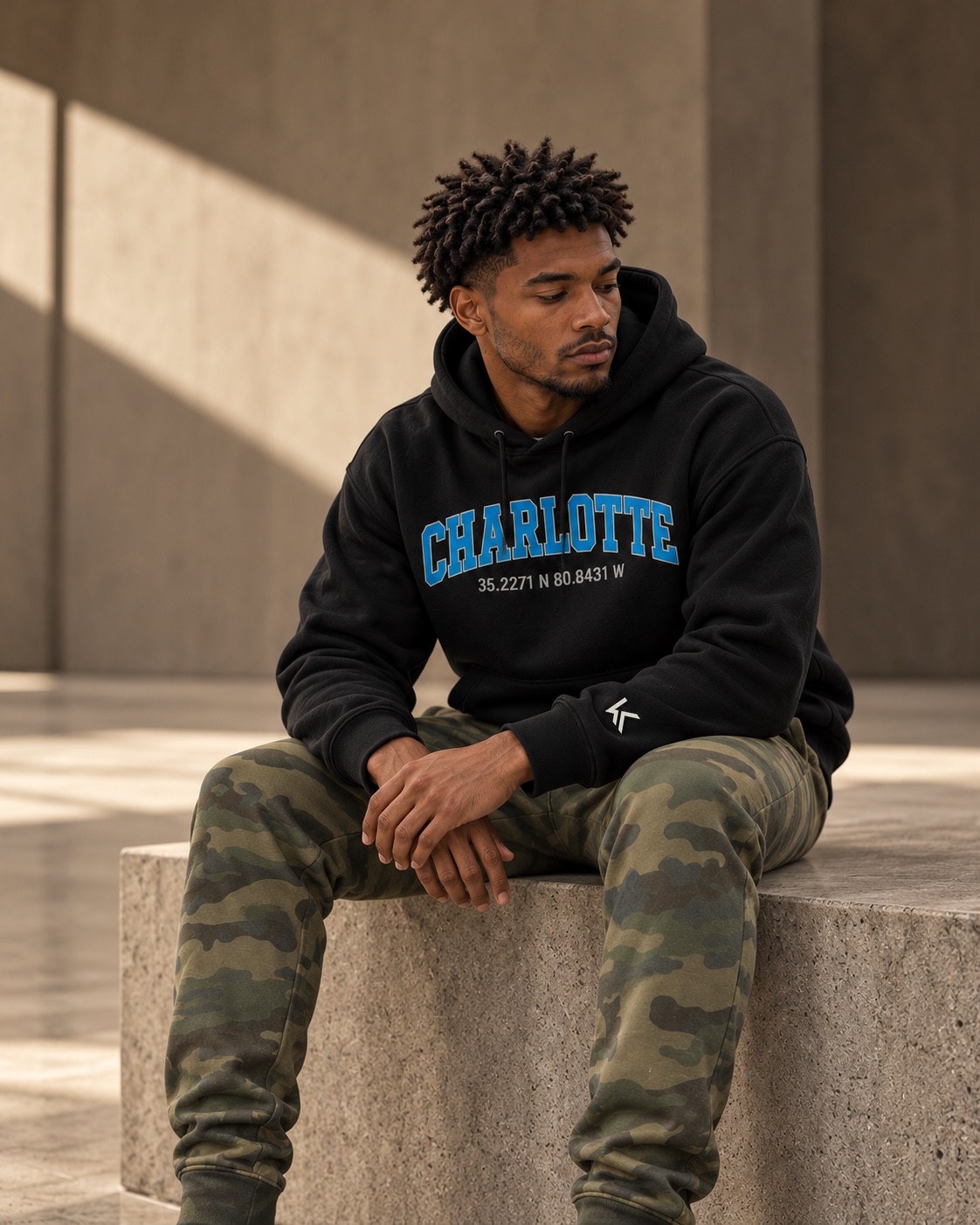 Black Charlotte hoodie styled with camouflage pants